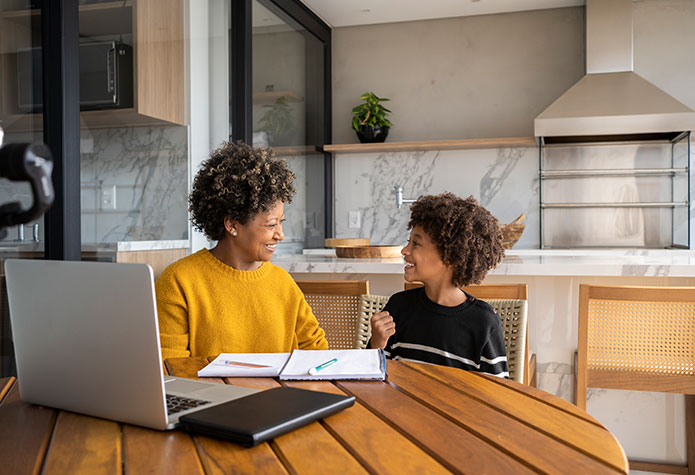 Student with parent studying at table
